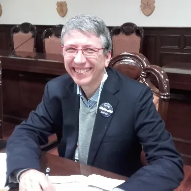 A person sitting at a table Description automatically generated with medium confidence